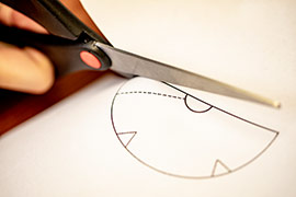 paper being cut in funnel shape