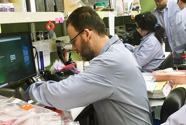 Geoff Baird processes a patient sample at UW Medical Center..