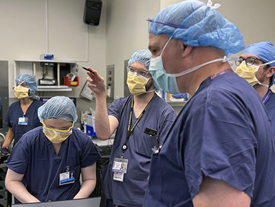 Several members of the brain implant team in the operating room