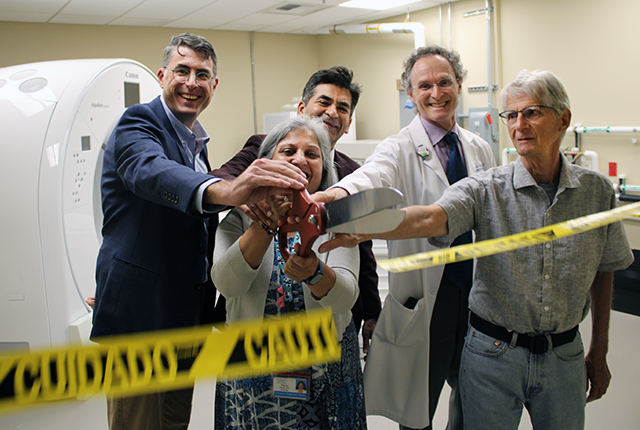 picture of King County and UW Medicine stakeholders cutting ceremonial ribbon on new CT scanner