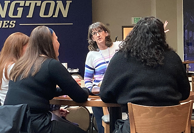 picture of Kelly Schloredt of the UW School of Medicine giving a suicide-awareness training to Husky student athletes.