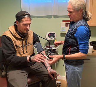 picture of nurse Kate Smith taking the pulse of patient Michael Carpenter