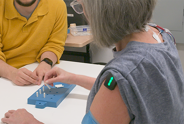 a study participant performs a dexterity exercise in the study