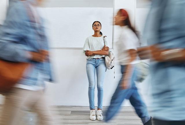 Woman standing alone in a hallway