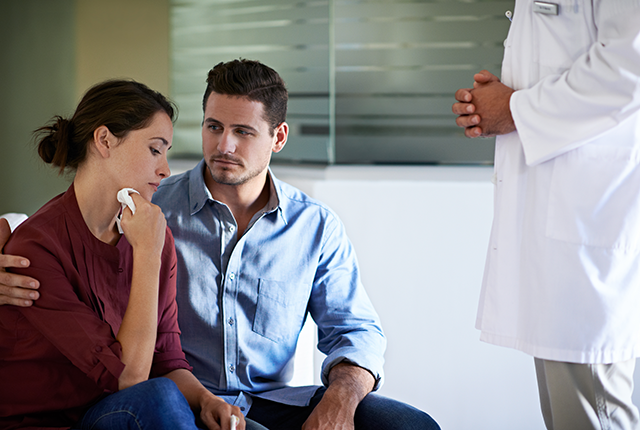 picture of a couple processing information given by a physician