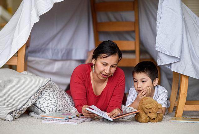 picture of a woman reading a book with a child