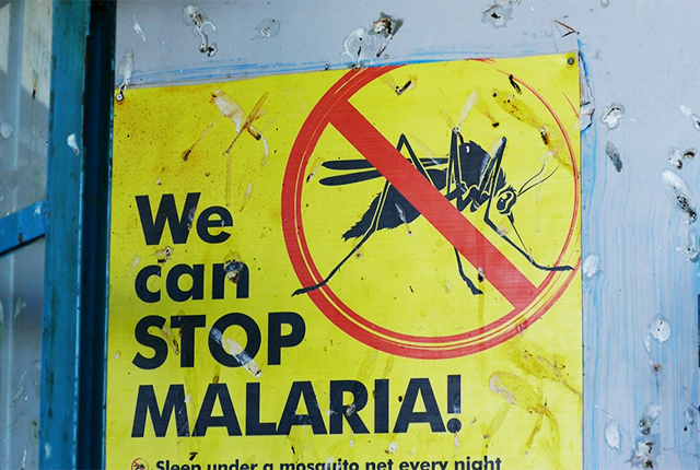 picture of a public poster warning about the danger of malaria in Uganda