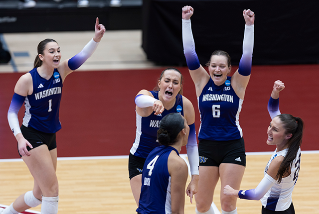 picture of the Elise Hani and the UW women's volleyball team celebrating a point during a match