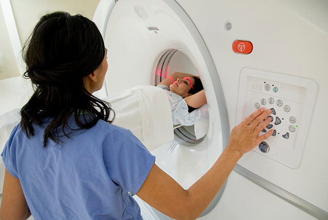 picture of UW Medicine technologist preparing a patient for a CT scan
