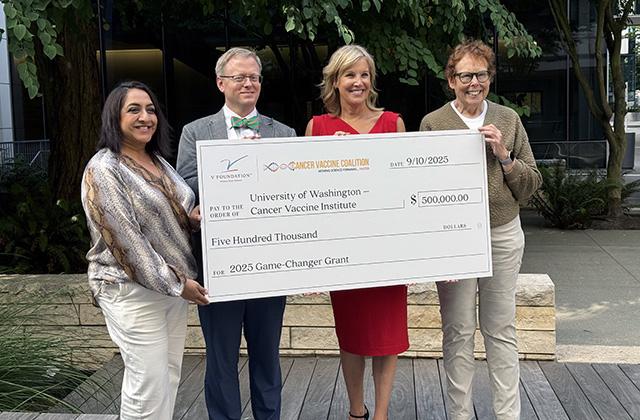 A supersized grant check for cancer vaccine research. Left to right: Kiran Dhillon, Will Gwin, Kristen Dahlgren and Nora Disis.