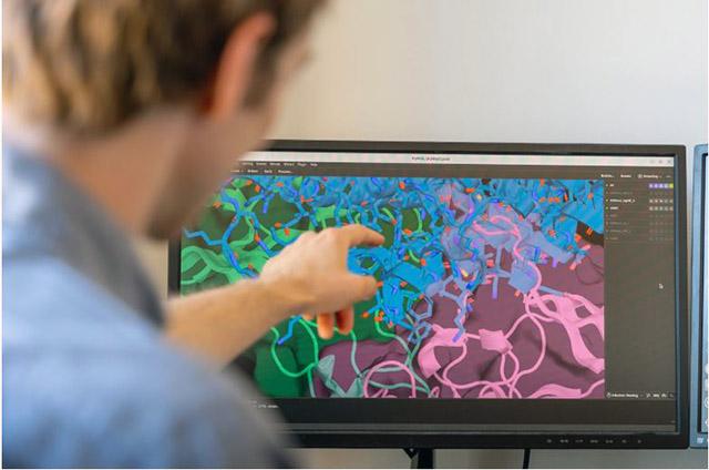 Chemical engineering Ph.D. student Adam Broerman examines a new anti-cancer protein that has built-in controls