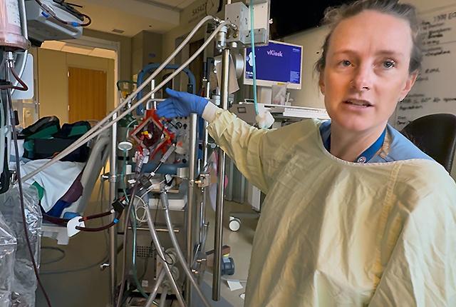 picture of Dr. Jenelle Badulak discussing the workings of an ECMO machine