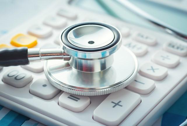 stethoscope on hand held calculator