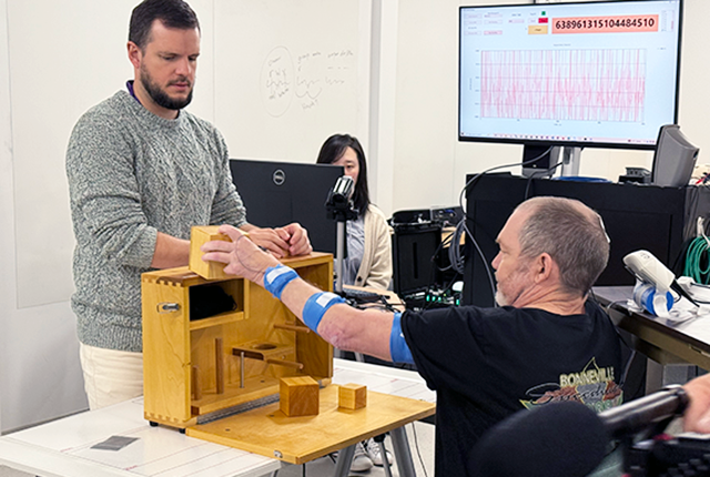 picture of Matt Kidd undergoing therapy to improve his fine-motor skills