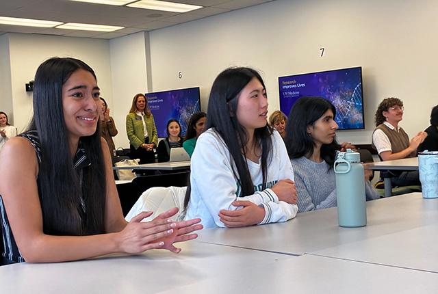 students studying lab medicine at the University of Washington react to hearing they will get tuition assistance