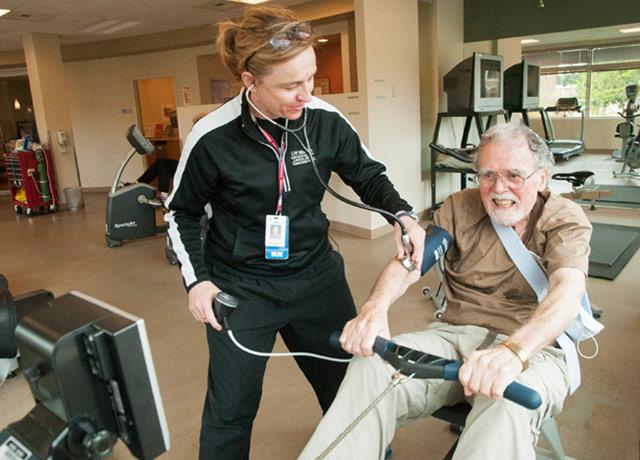 Media Name: display-lisa_grachan_rn_monitors_john_webber_during_cardiac_rehab_at_nwh.jpg