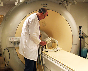 ​ Todd Richards with a head-coil apparatus that detects brain signals in subjects on the fMRI scanner. ​